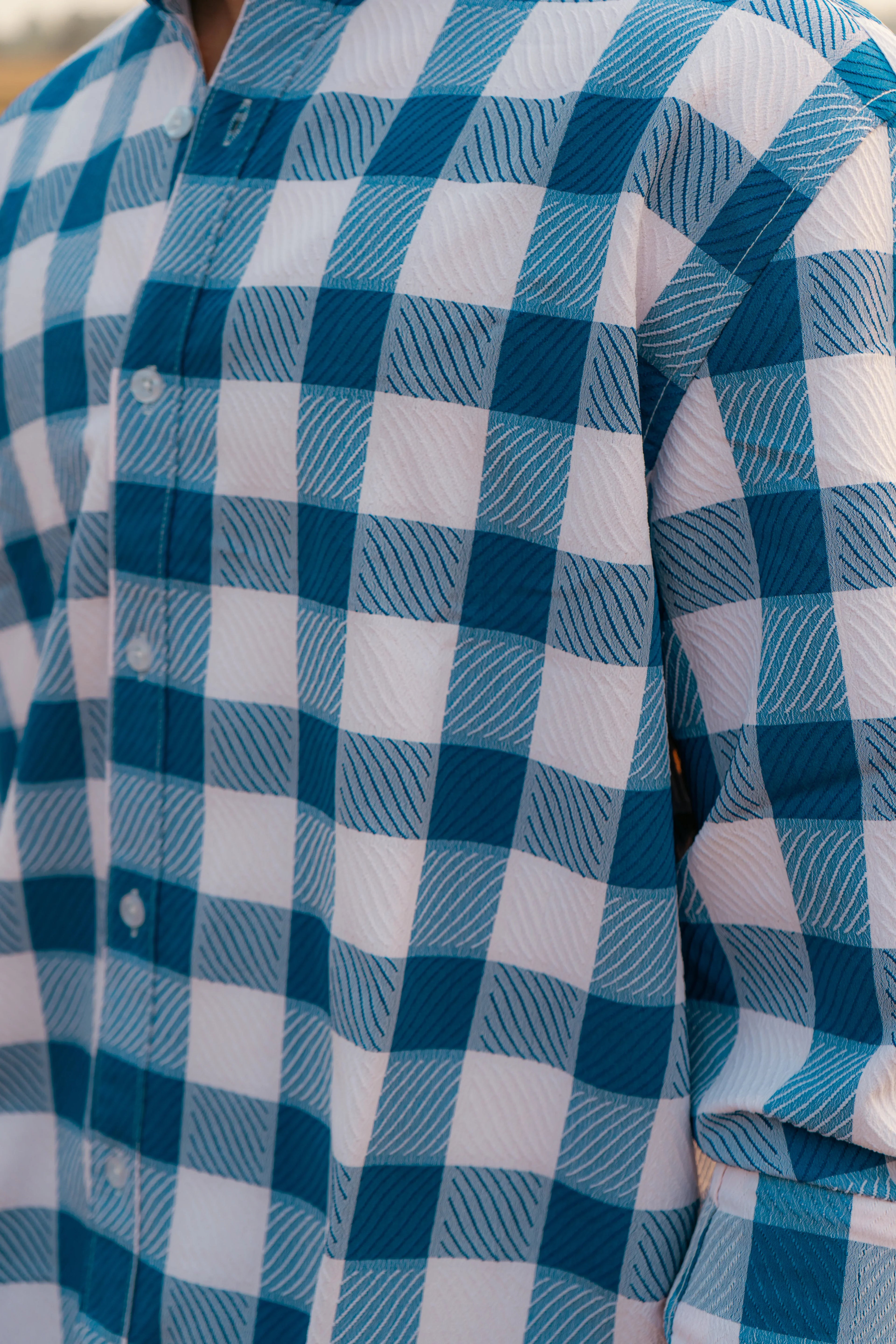 Close-up of blue and white checkered button-up shirt with textured pattern